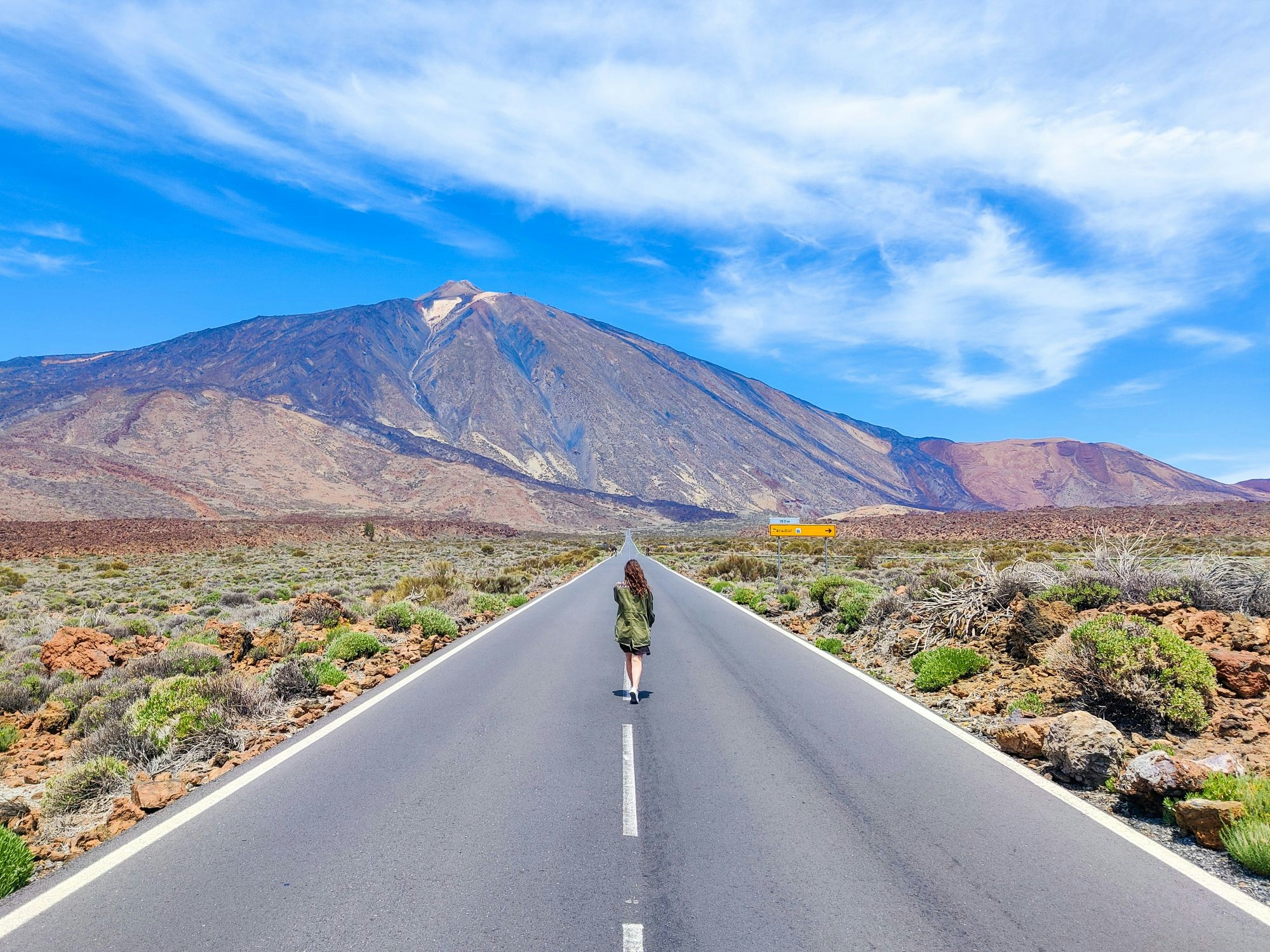 Une fille qui marche sur la route devant le Teide